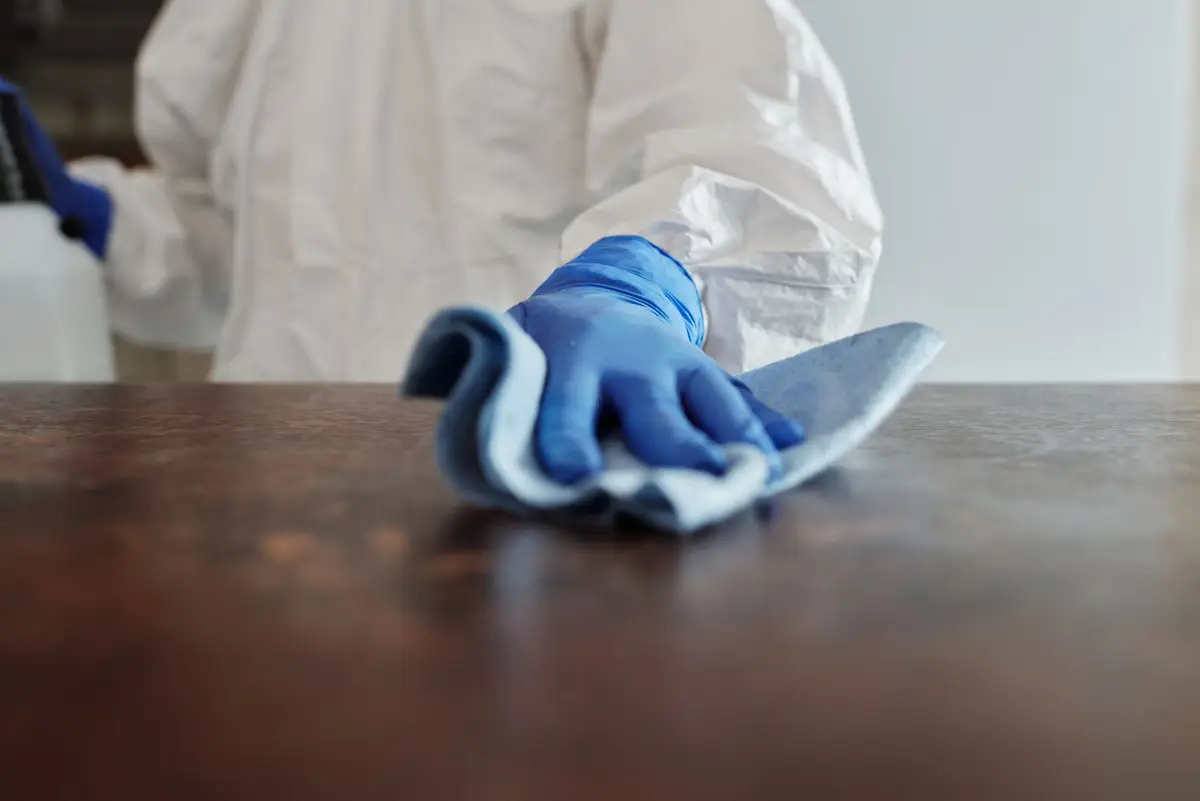 A housekeeper cleaning a table